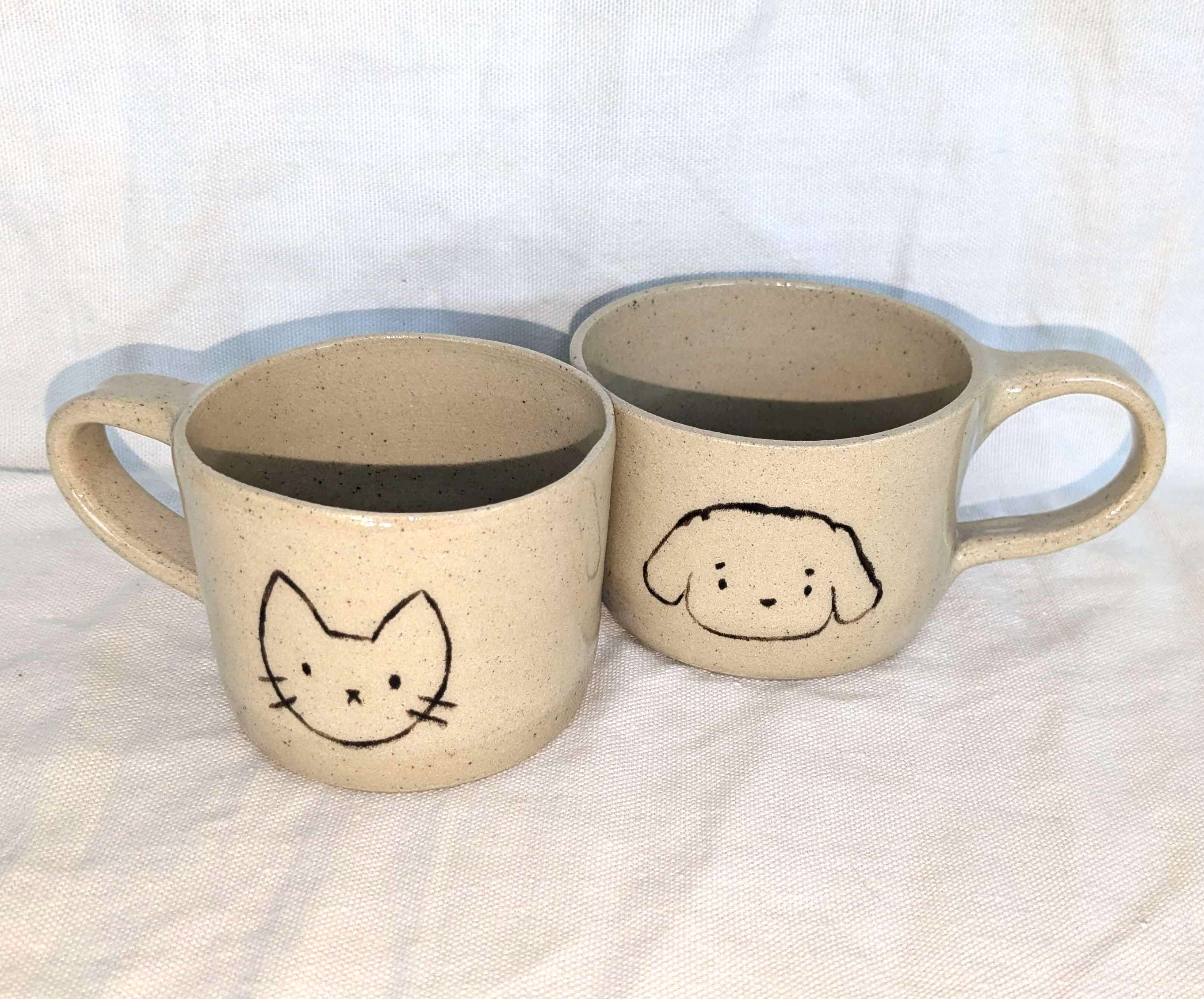 two mugs, one with a cat and one with a dog