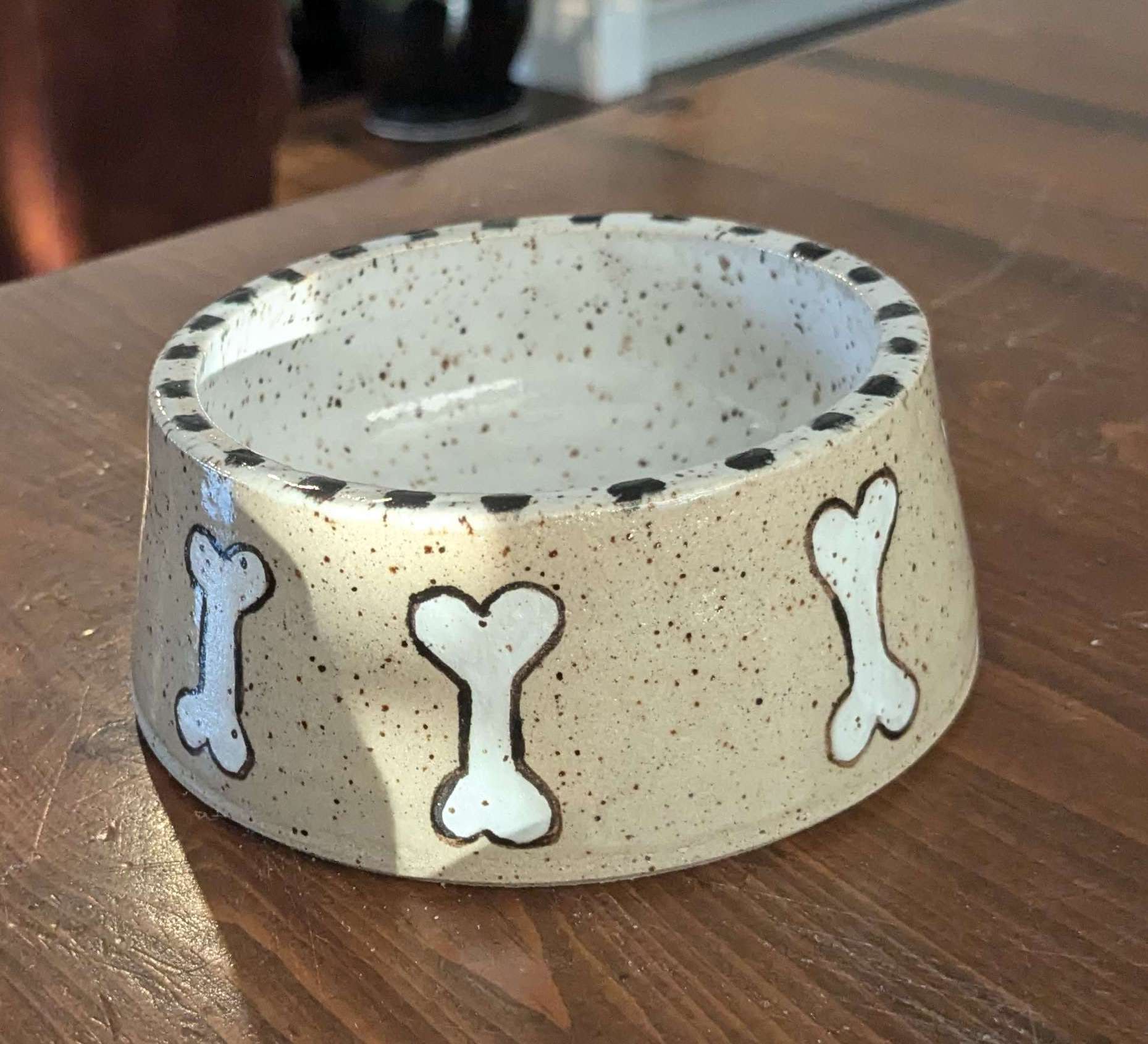 dog bowl with many bones on it