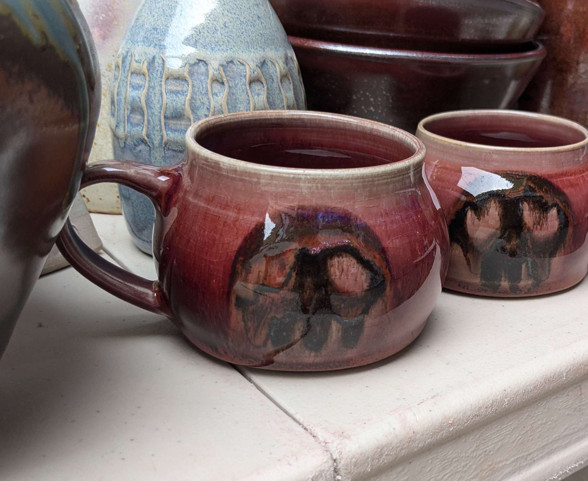 two reg mugs with skulls on them