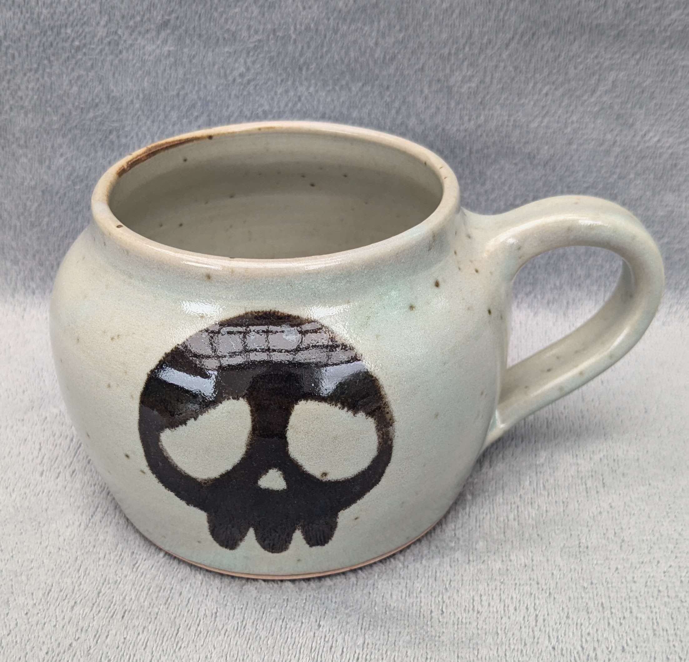 white mug with black skull